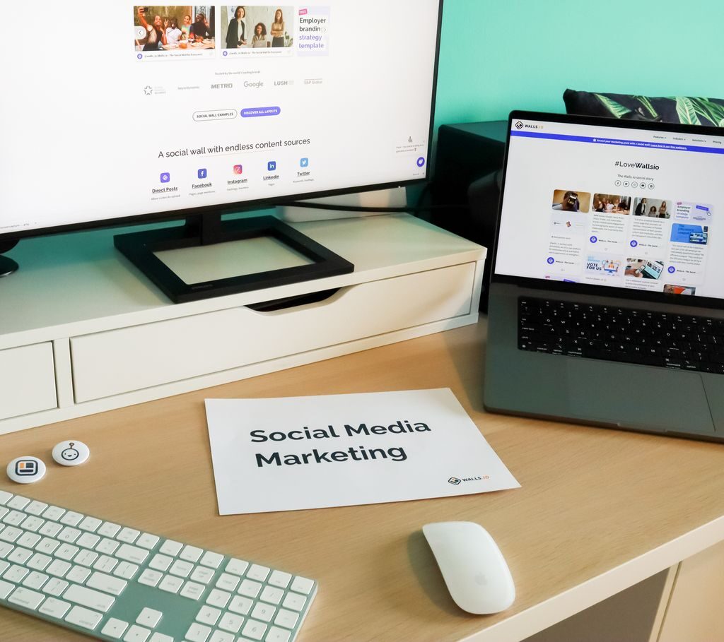 Stylish workspace with laptop and monitor for social media marketing.
